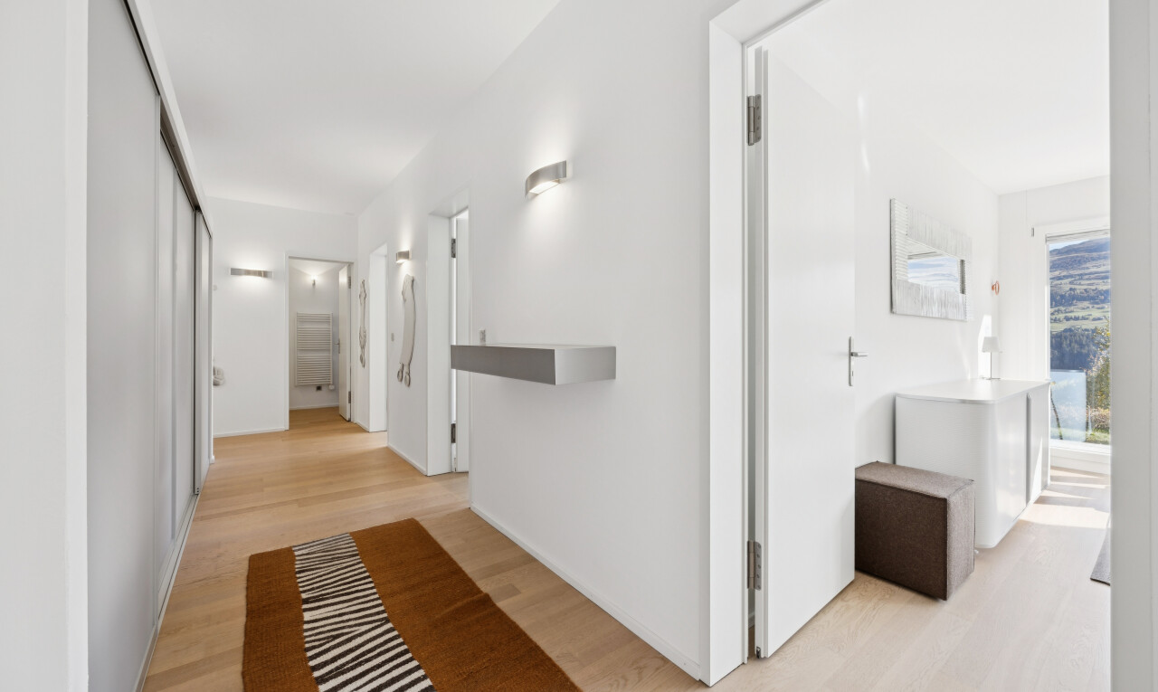 hall with light wood-type flooring and a closet