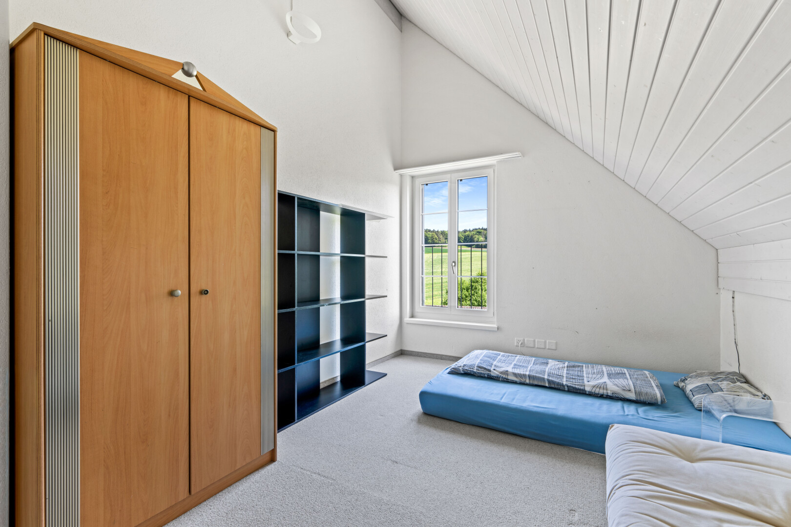 room with light carpet and a vaulted wood ceiling