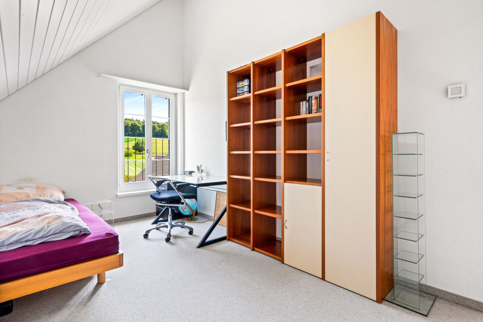 room with vaulted ceiling, light carpet, and a desk