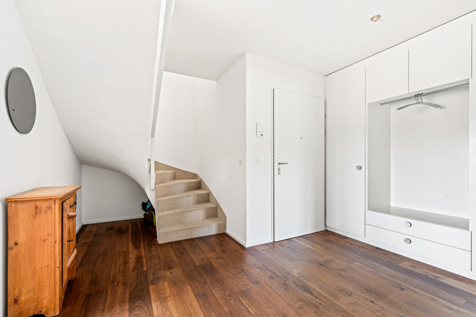 stairway with hardwood / wood-style flooring