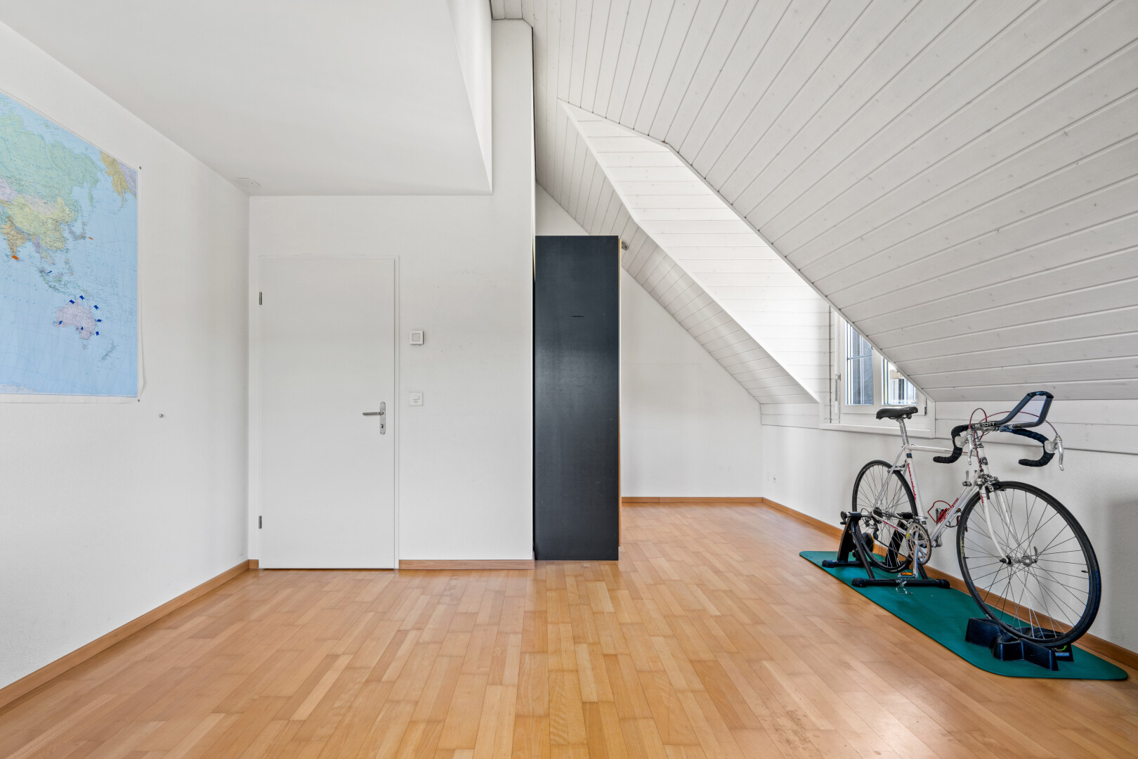 exercise room featuring light wood-style flooring and a vaulted wooden ceiling