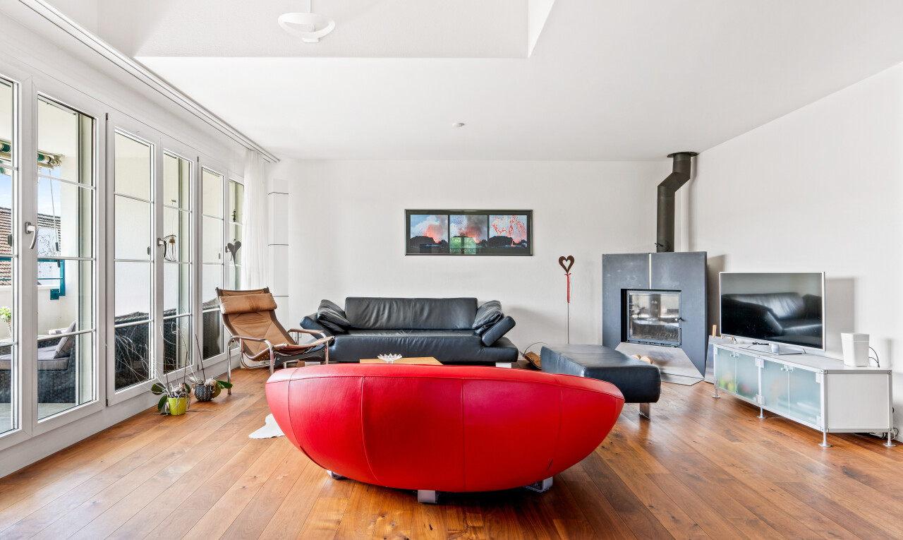 living room featuring a wood stove and light wood-style floors