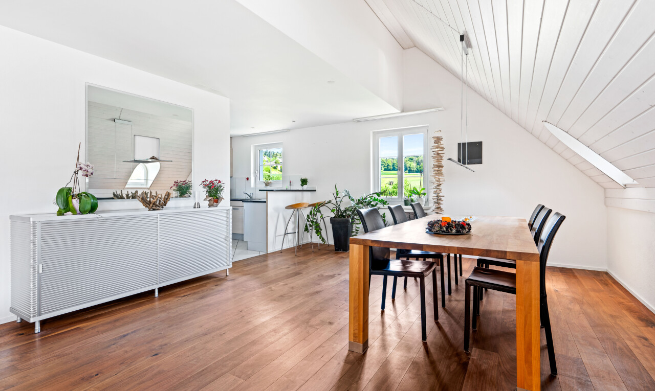 dining space with hardwood / wood-style flooring, a vaulted wooden ceiling, and a skylight