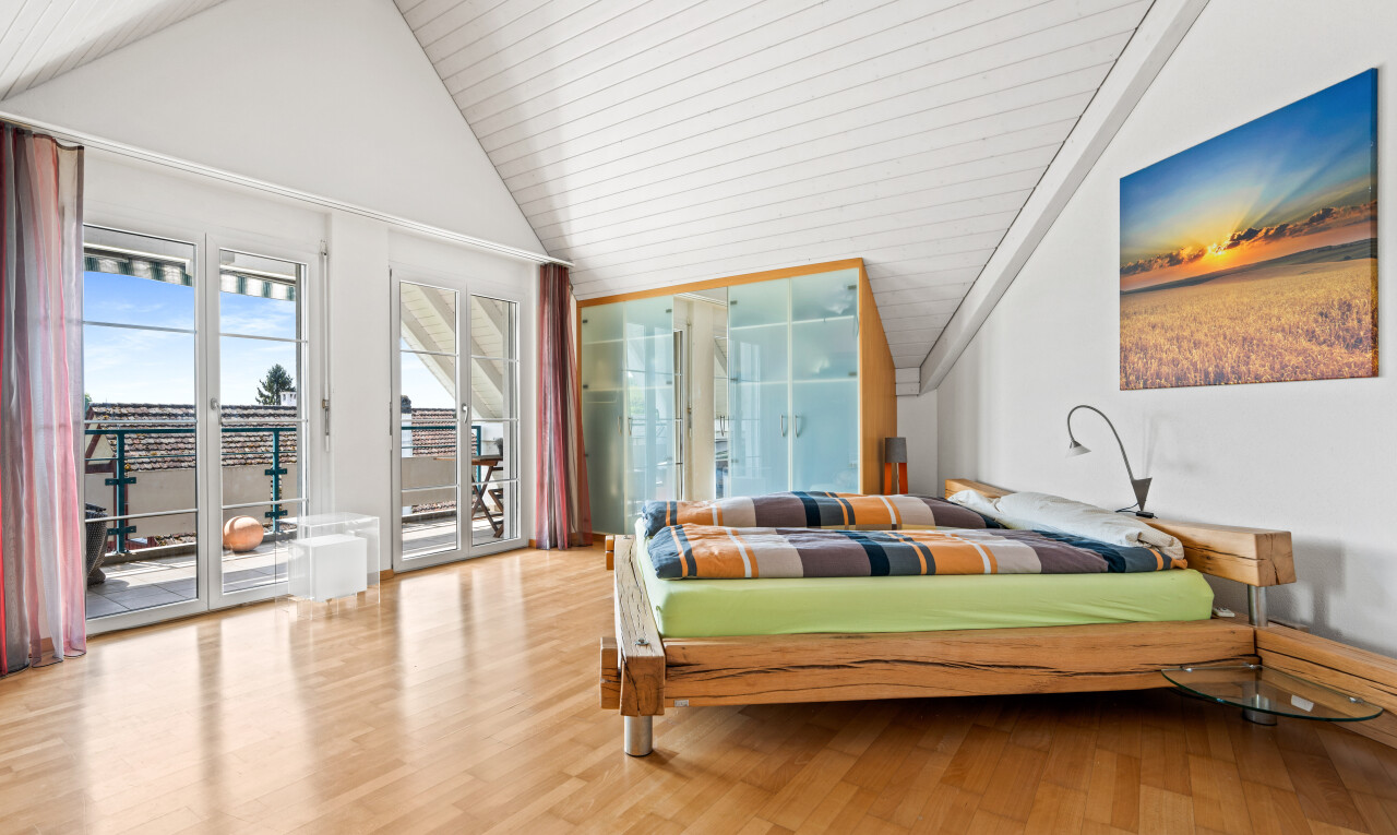room / bedroom featuring wood finished floors, vaulted ceiling, and access to outside