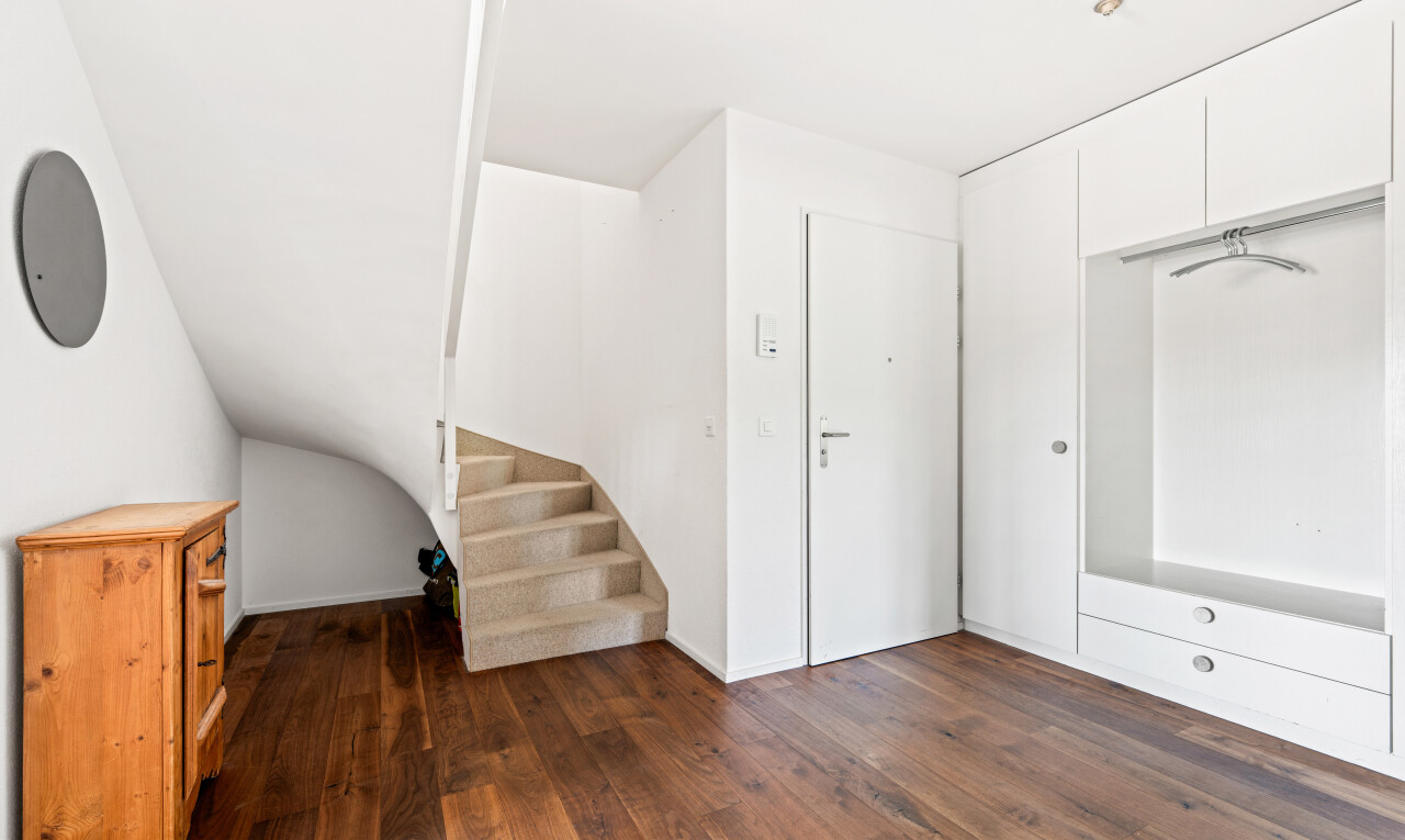stairway with hardwood / wood-style flooring