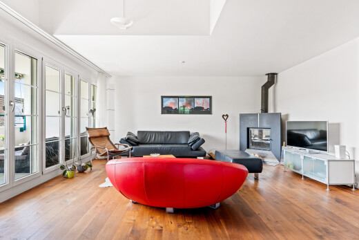 living room featuring a wood stove and light wood-style floors
