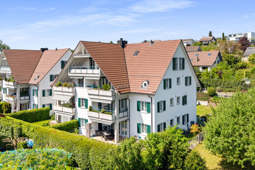 view of home with a tiled roof and a chimney