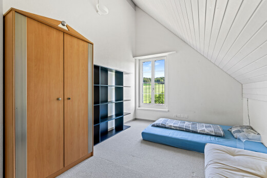 room with light carpet and a vaulted wood ceiling