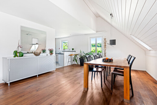 dining space with hardwood / wood-style flooring, a vaulted wooden ceiling, and a skylight