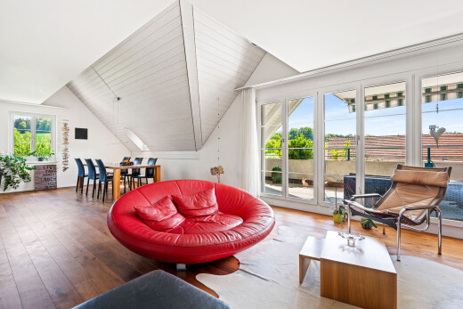 living / dining area featuring hardwood / wood-style floors and vaulted ceiling