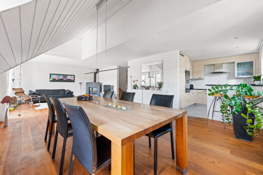 dining space with light wood finished floors, lofted ceiling, and a ceiling fan