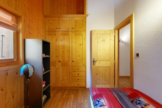 chambre avec wood finish floor, sol en finition bois, placard, inside property, et lumière naturelle