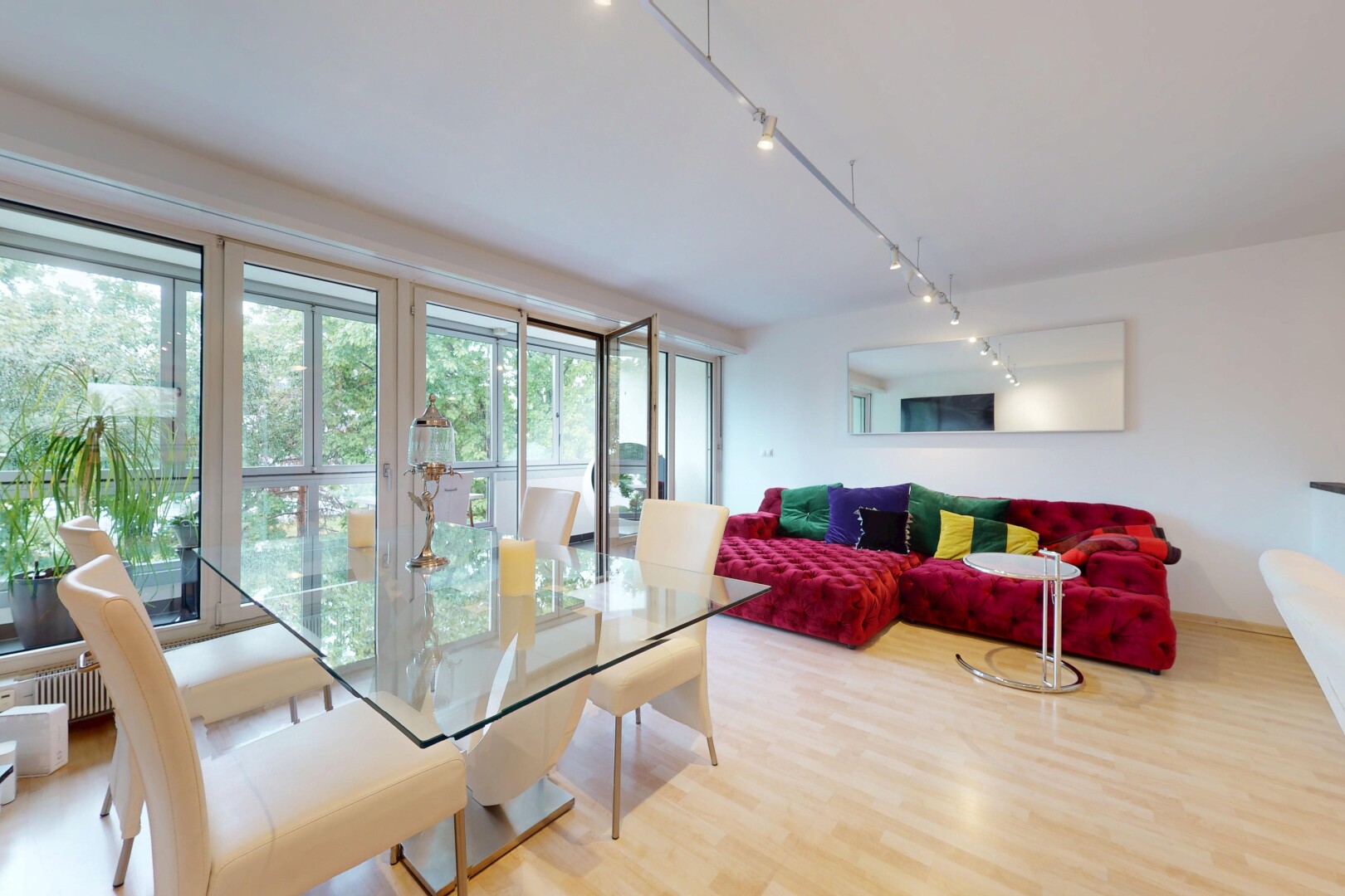 living / dining room with rail lighting and wood finished floors