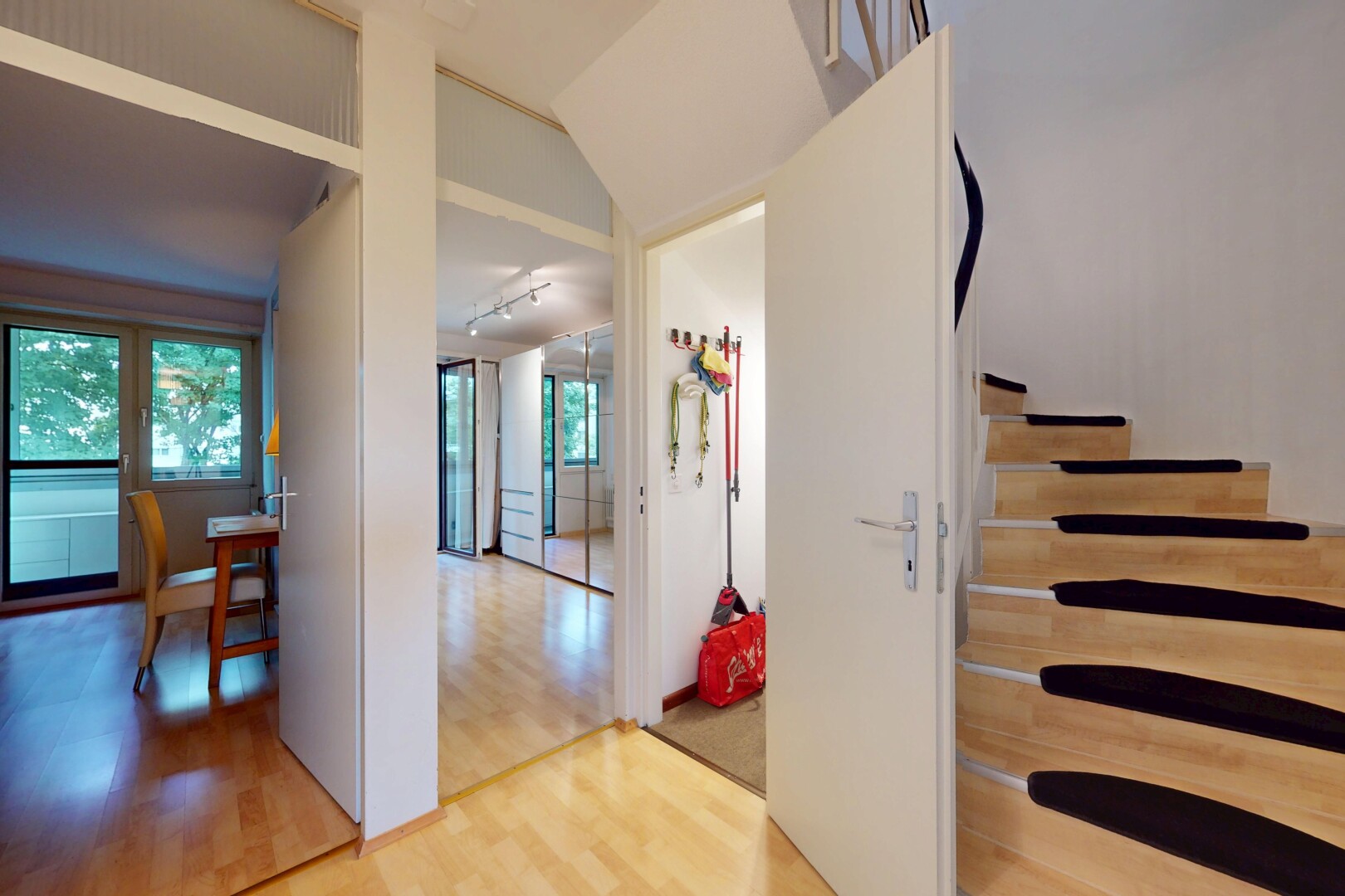 stairway featuring wood finished floors and rail lighting
