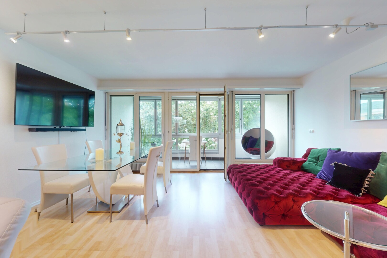 living / dining area with wood finished floors and rail lighting