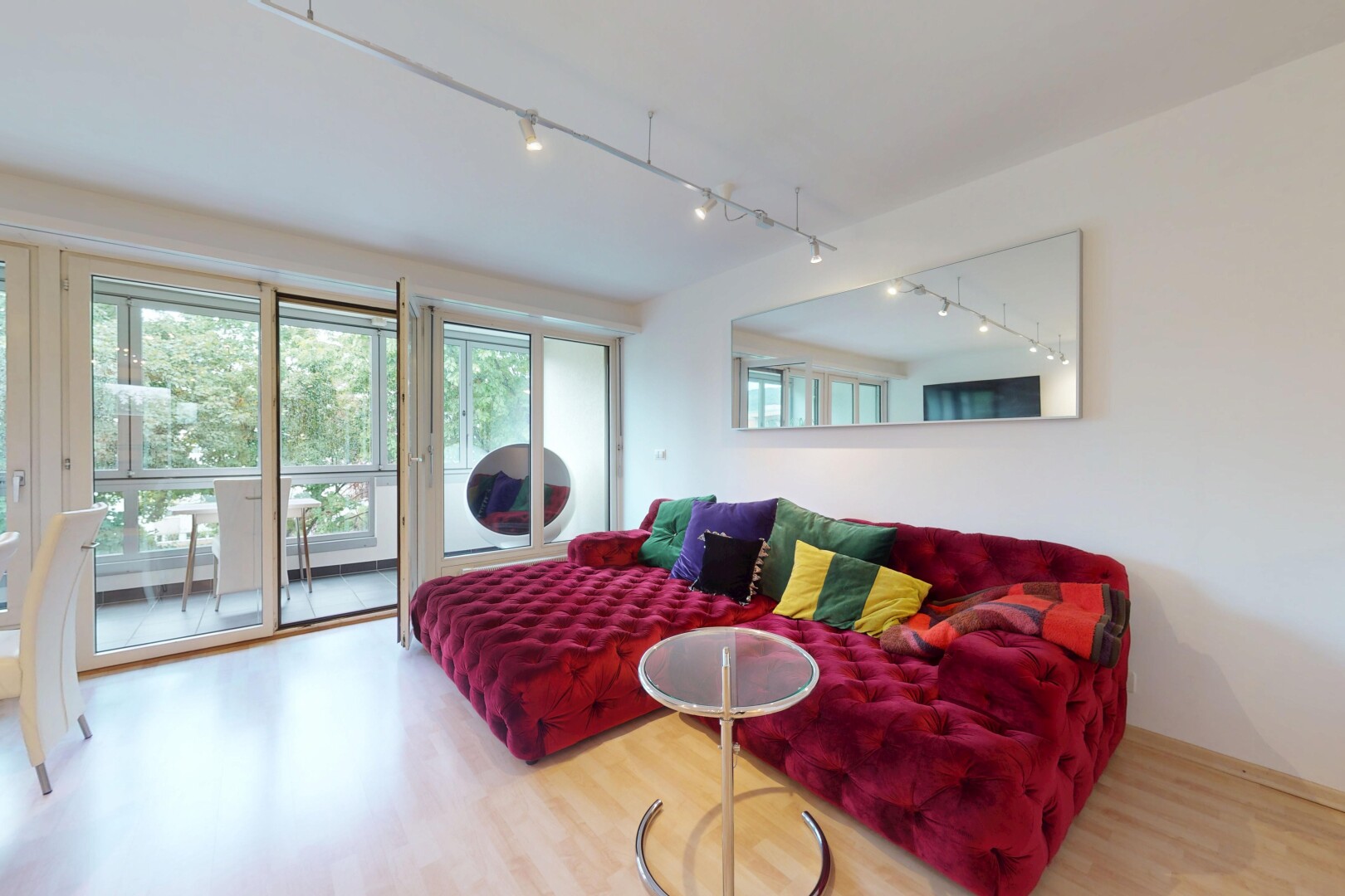 living room with rail lighting and wood finished floors