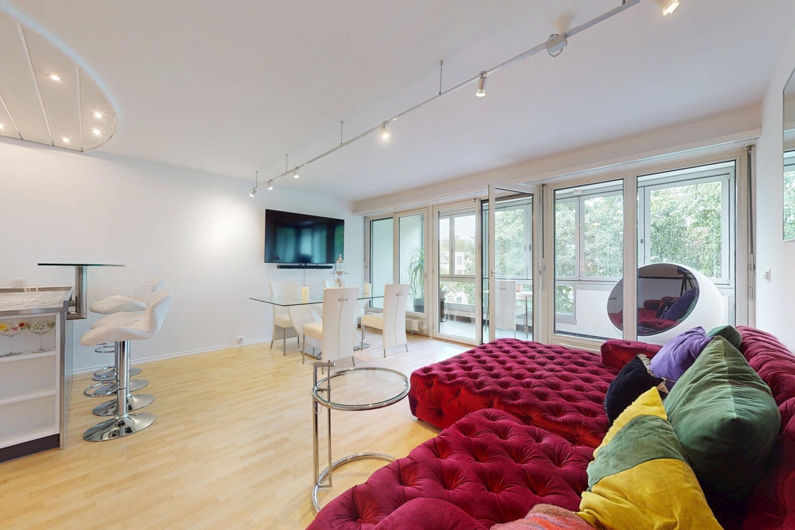 living / dining area with track lighting and wood finished floors