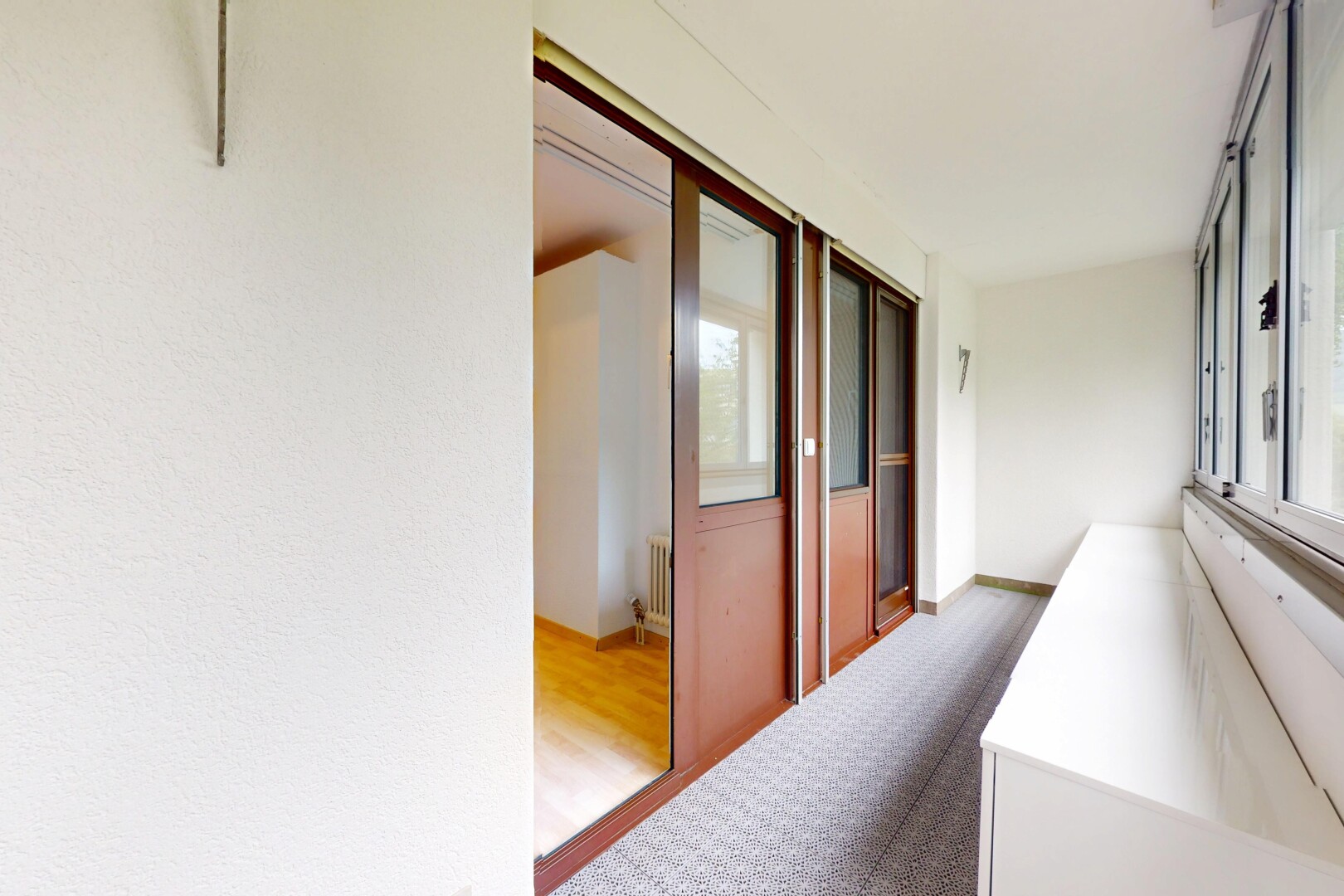 hallway featuring wood finished floors and radiator heating unit