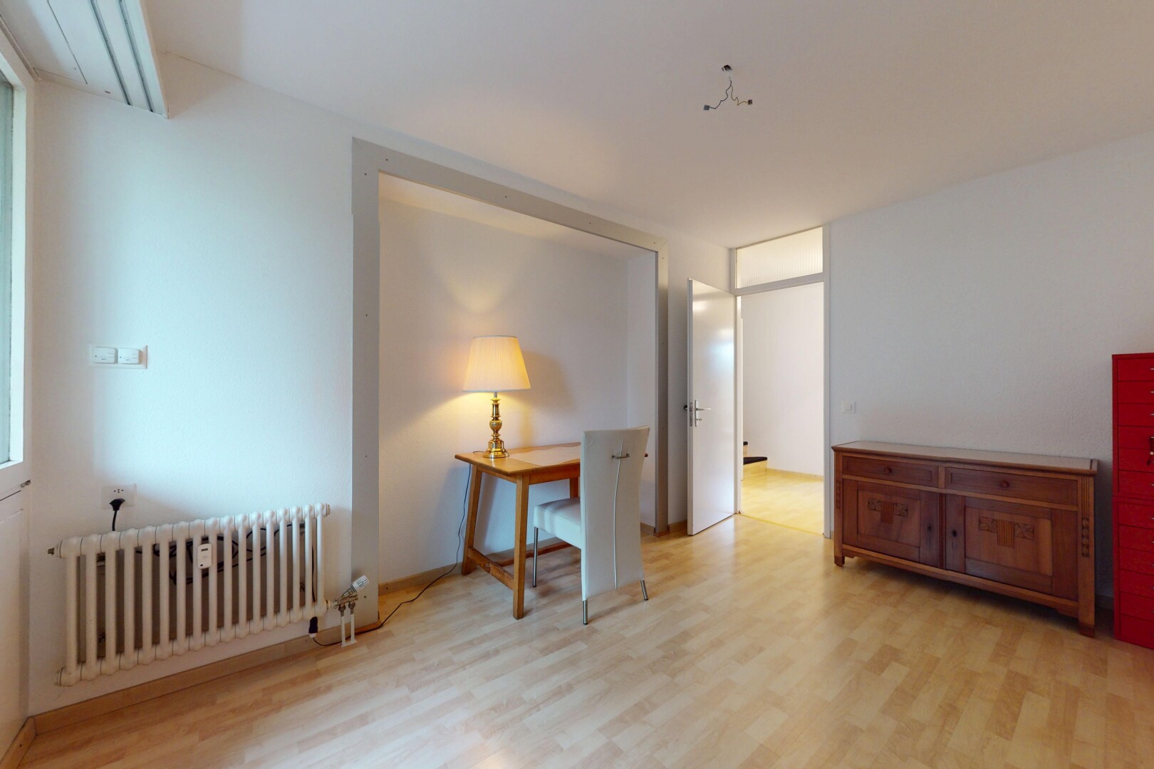 spare room featuring radiator heating unit and light wood-type flooring