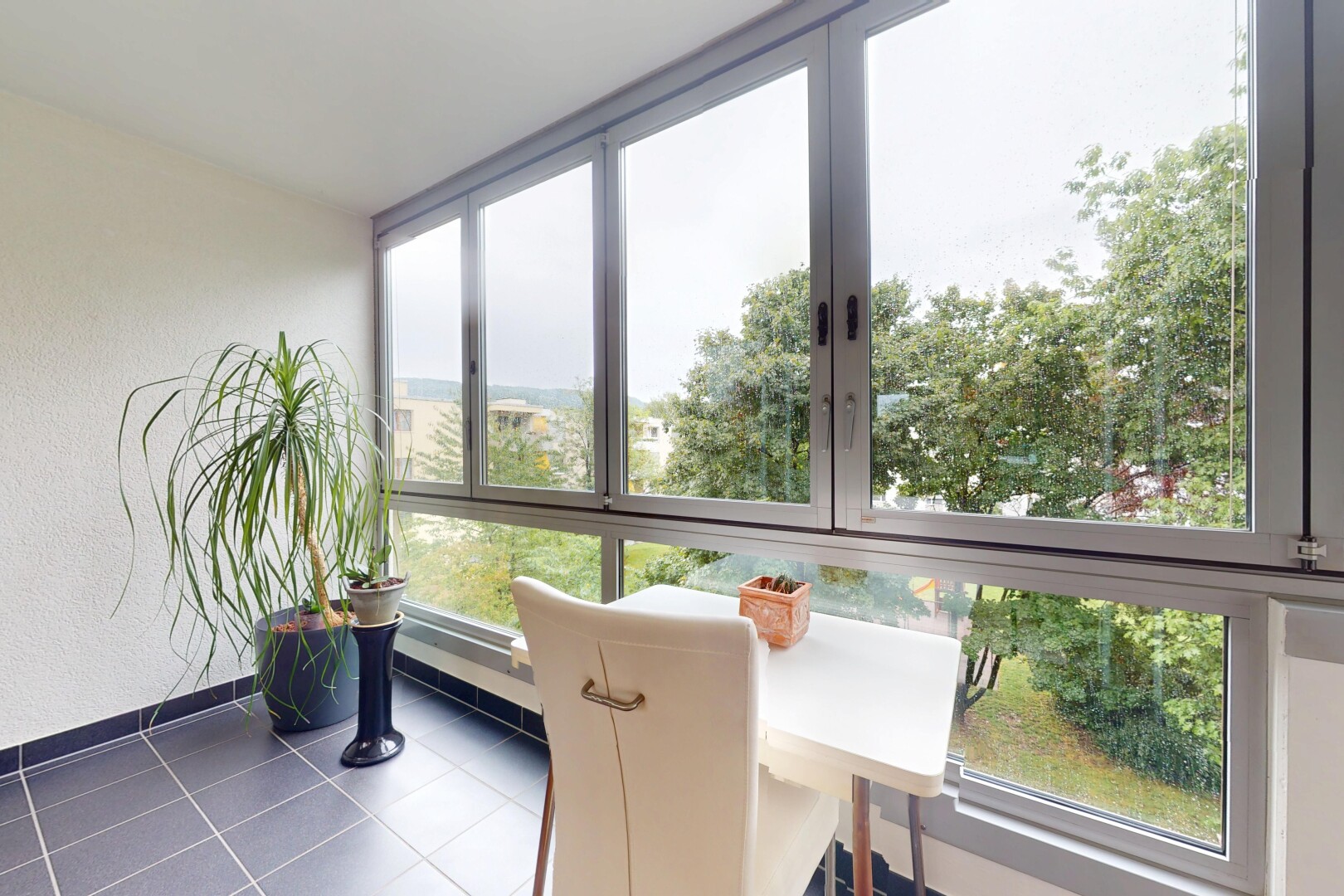 tiled dining space featuring baseboards