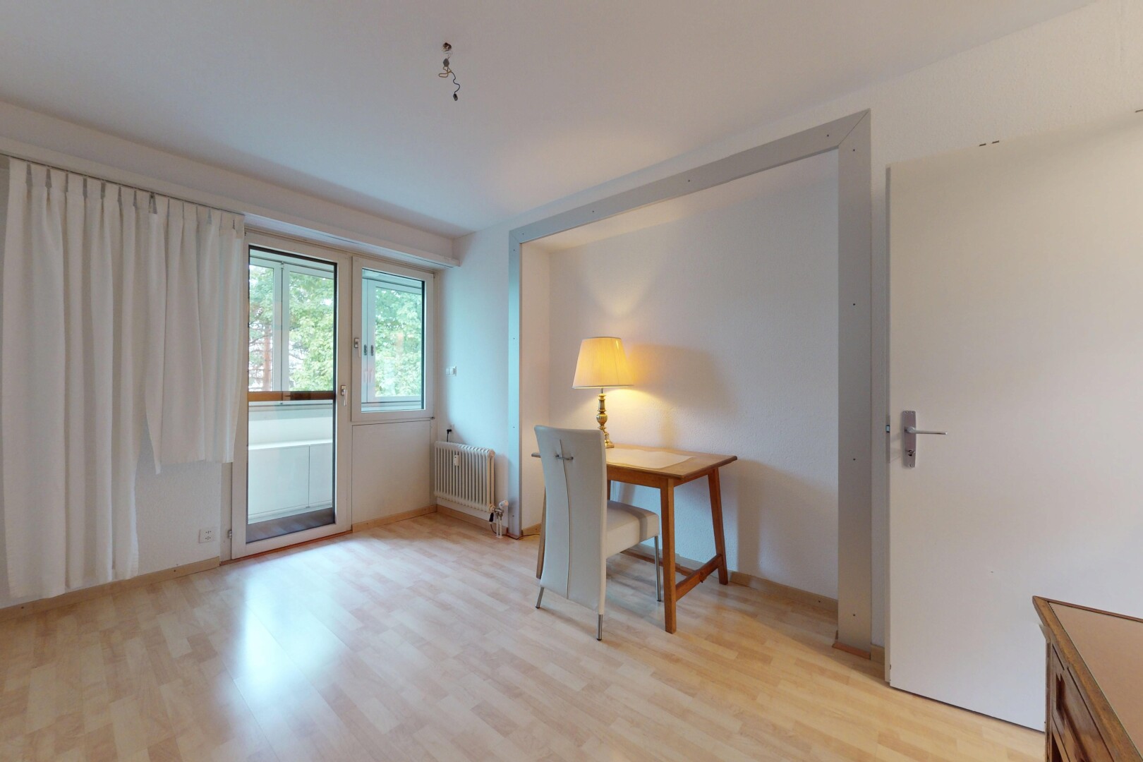 unfurnished room featuring light wood-style flooring and radiator heating unit