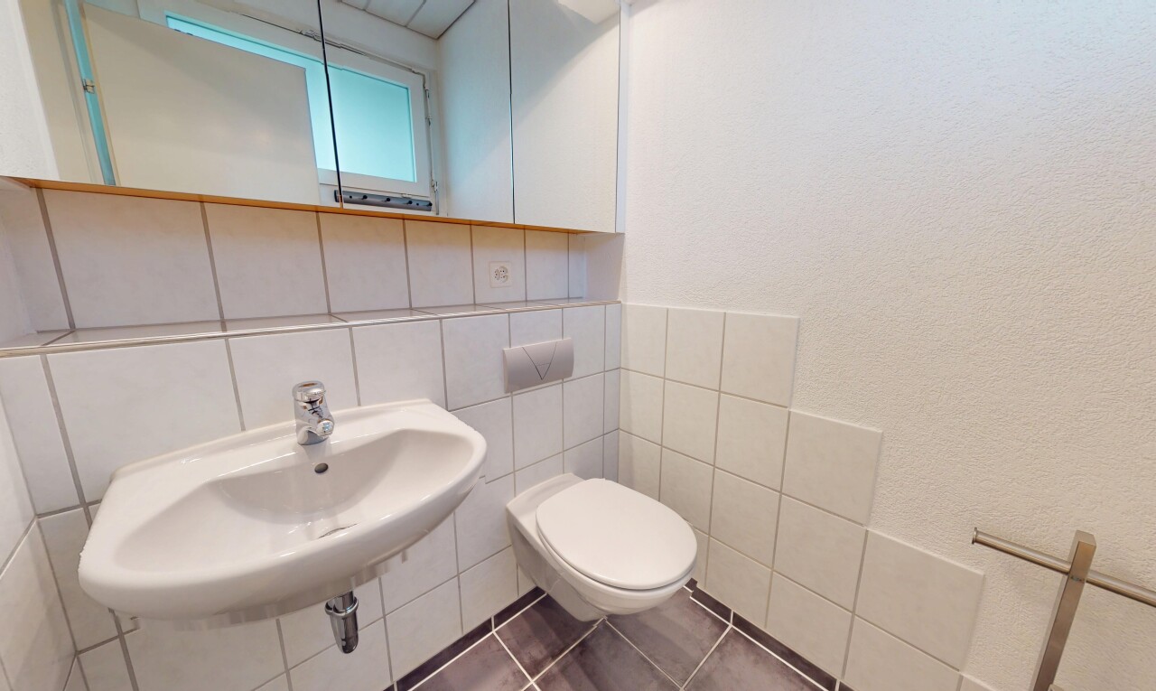 bathroom featuring tile patterned flooring, tile walls, and a textured wall