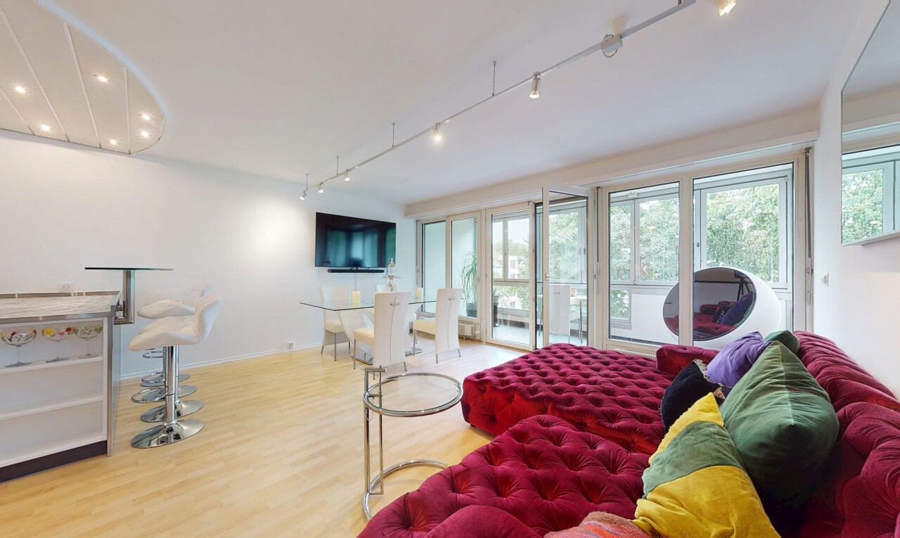 living / dining area with track lighting and wood finished floors