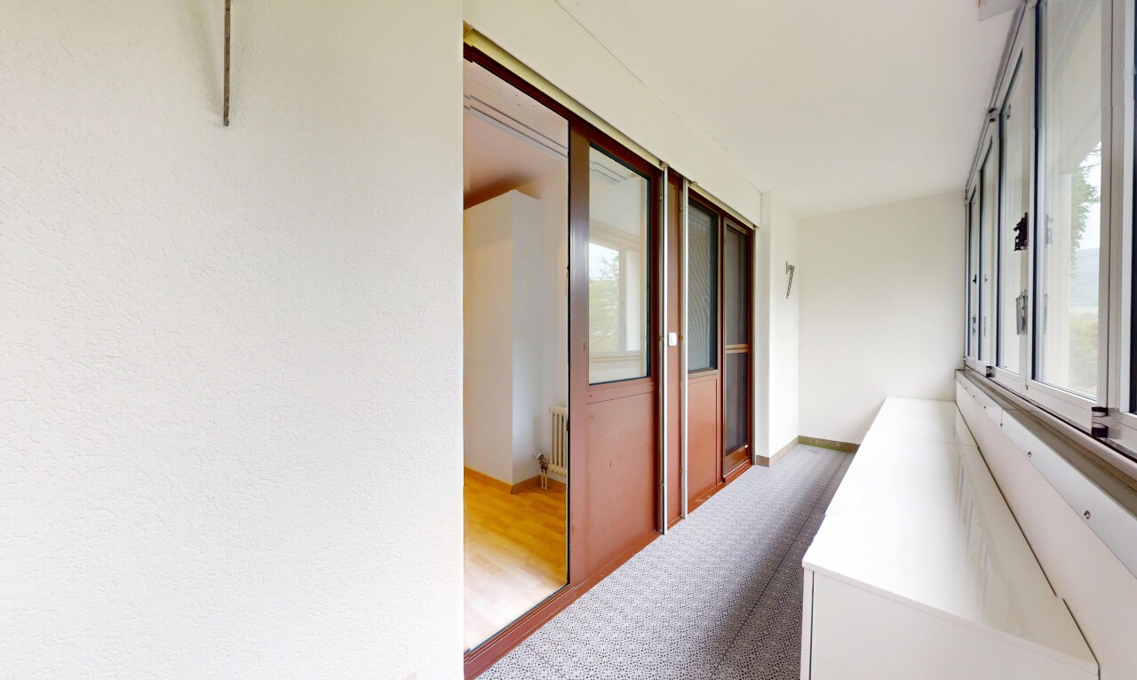 hallway featuring wood finished floors and radiator heating unit