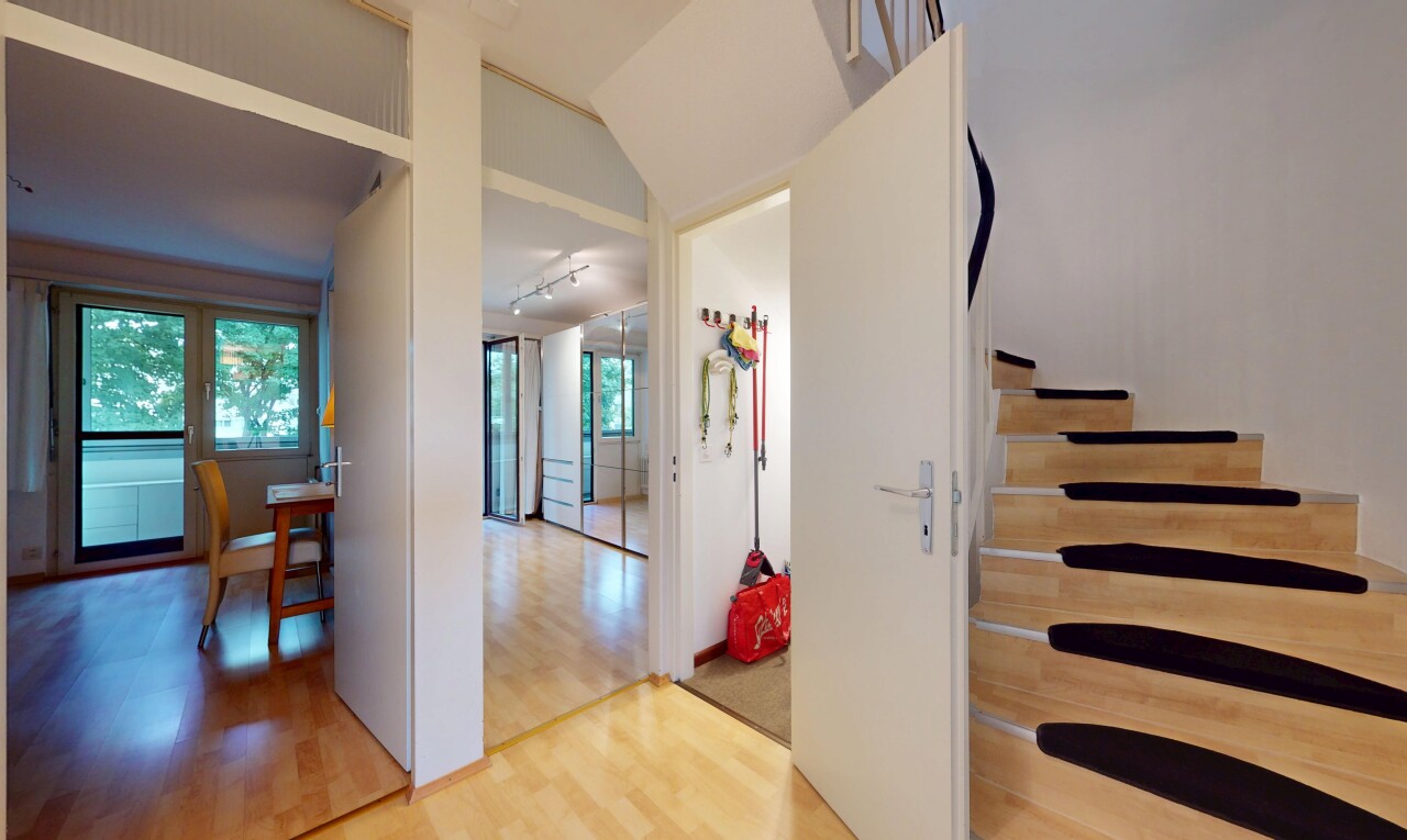 stairway featuring wood finished floors and rail lighting