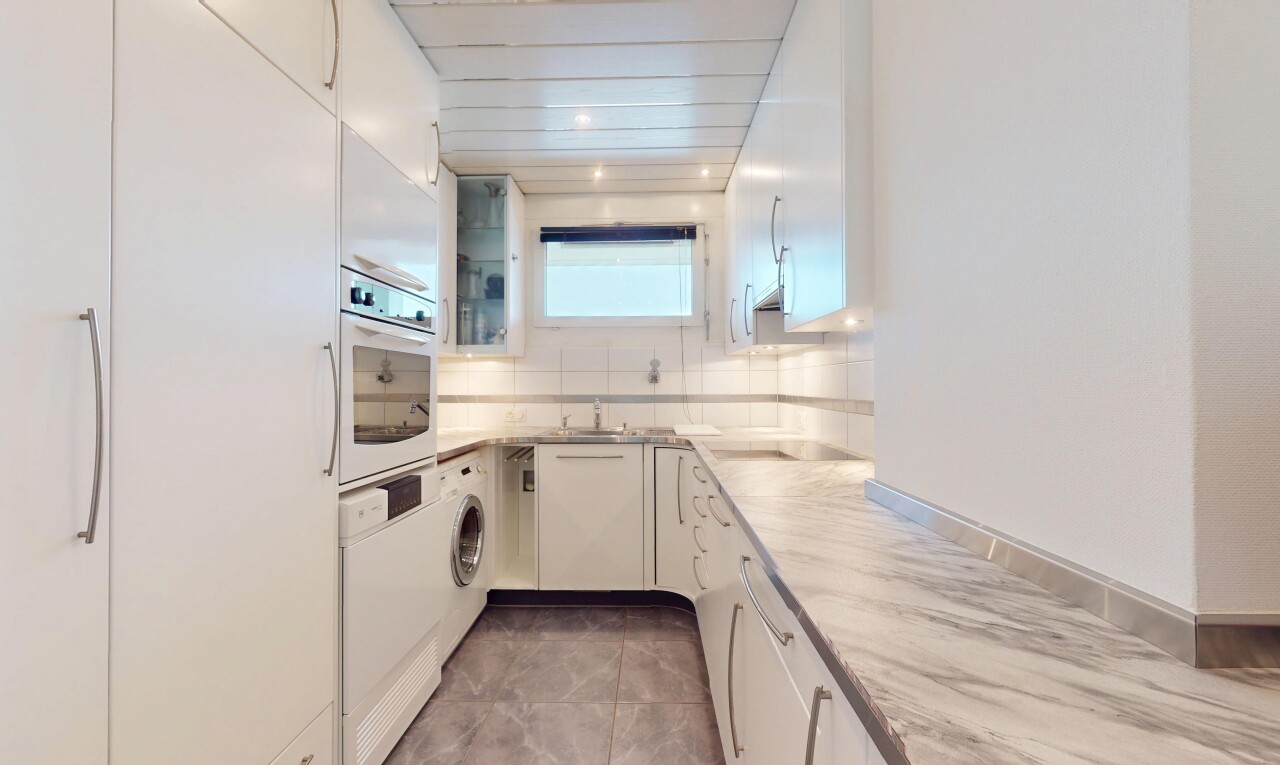 kitchen with glass insert cabinets, tasteful backsplash, white appliances, and white cabinetry