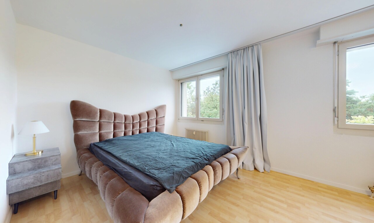 room / bedroom with wood finished floors and radiator