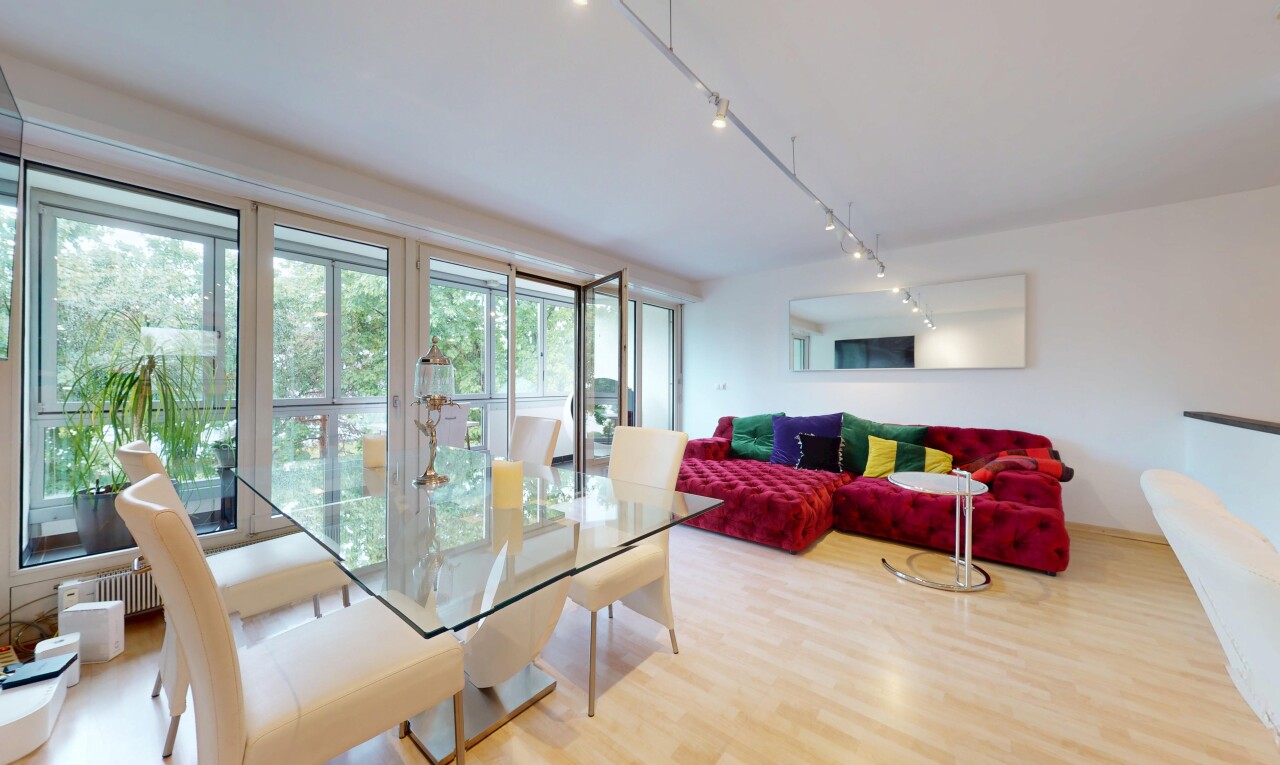 living / dining room with rail lighting and wood finished floors