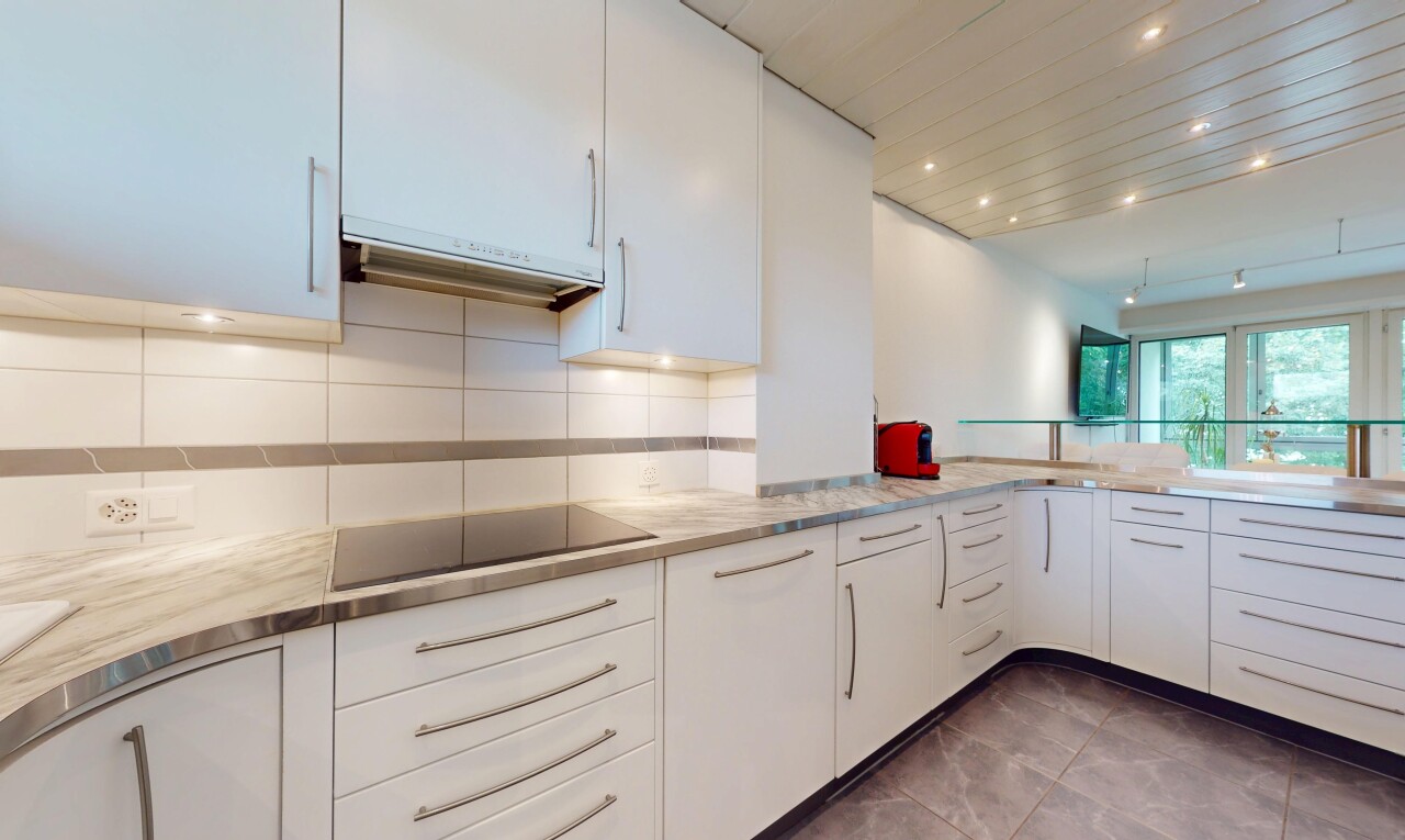 kitchen featuring white cabinetry, extractor fan, backsplash, light countertops, and recessed lighting
