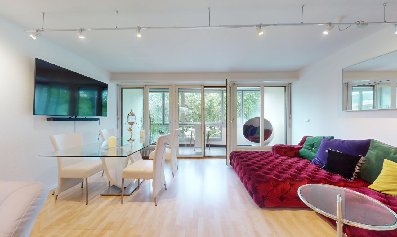 living / dining area with wood finished floors and rail lighting