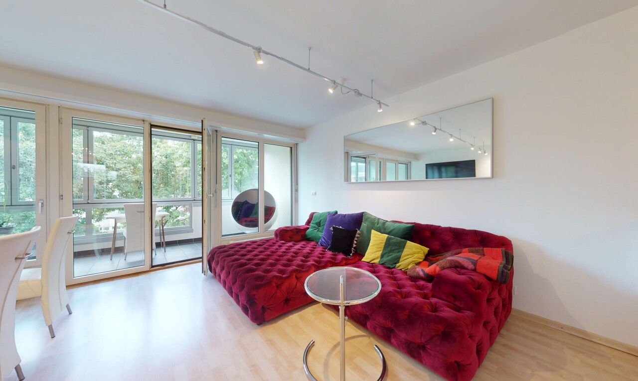 living room with rail lighting and wood finished floors