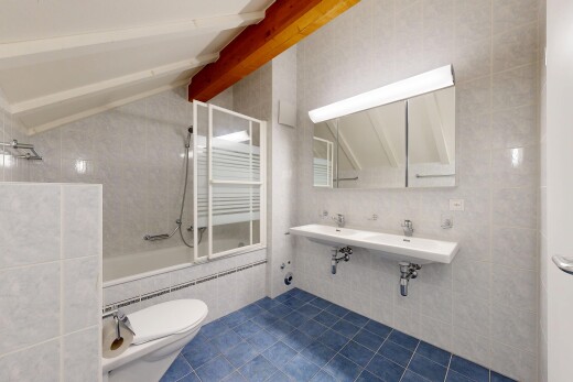 salle de bains avec mur en carrelage, tile wall, miroir, douche-bain combinés, et dark floor