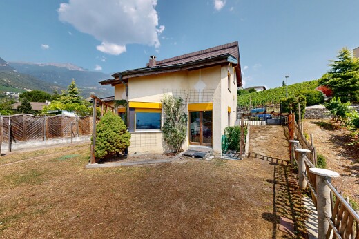 view of home featuring a fenced backyard, a chimney, and stucco siding