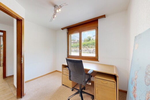 office area with track lighting and light colored carpet