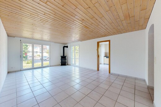 empty room featuring a wood stove, wood ceiling, and light tile patterned flooring