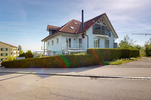 outdoor house featuring a balcony and stucco siding