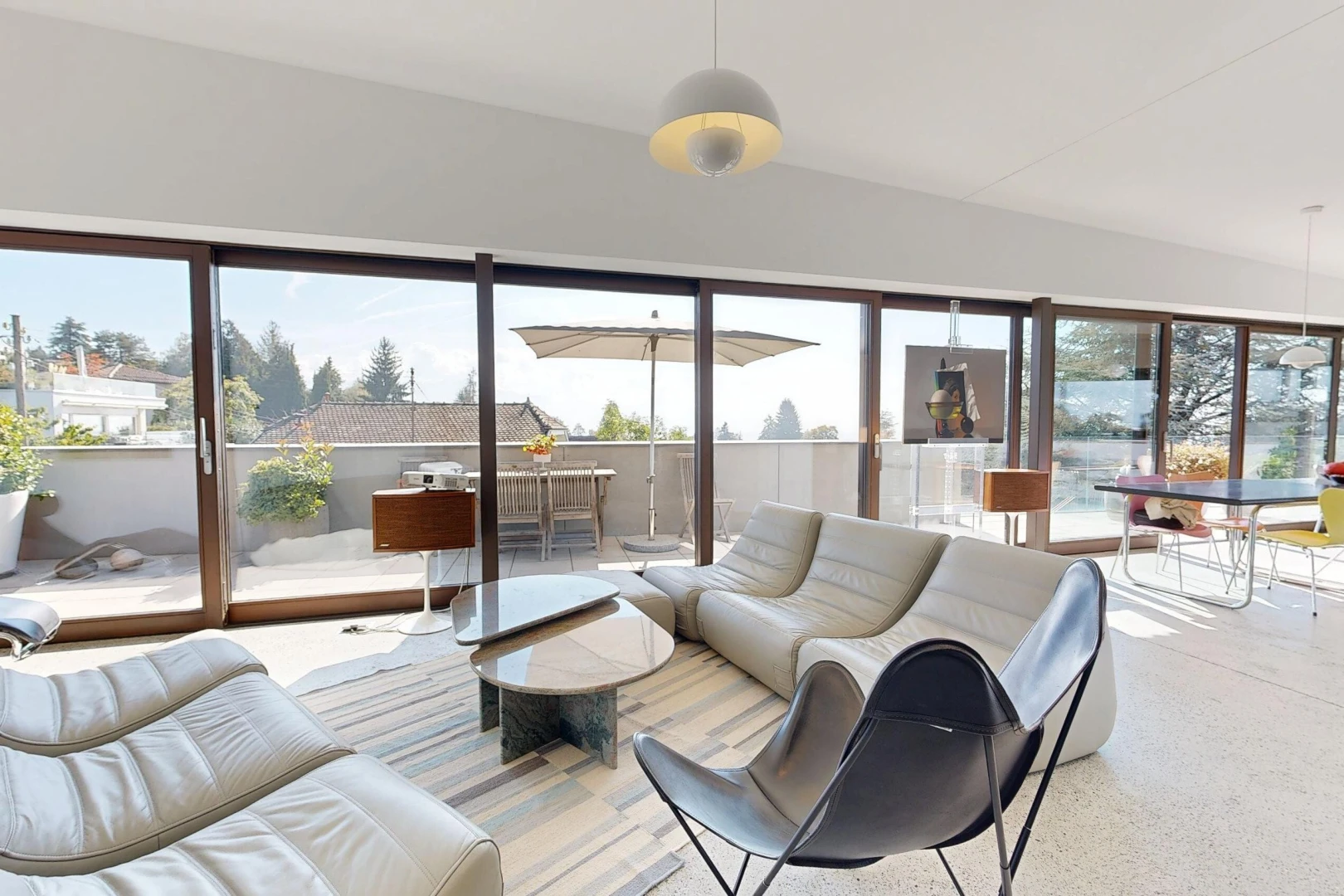 living area featuring pendant lighting, access to exterior, and lofted ceiling