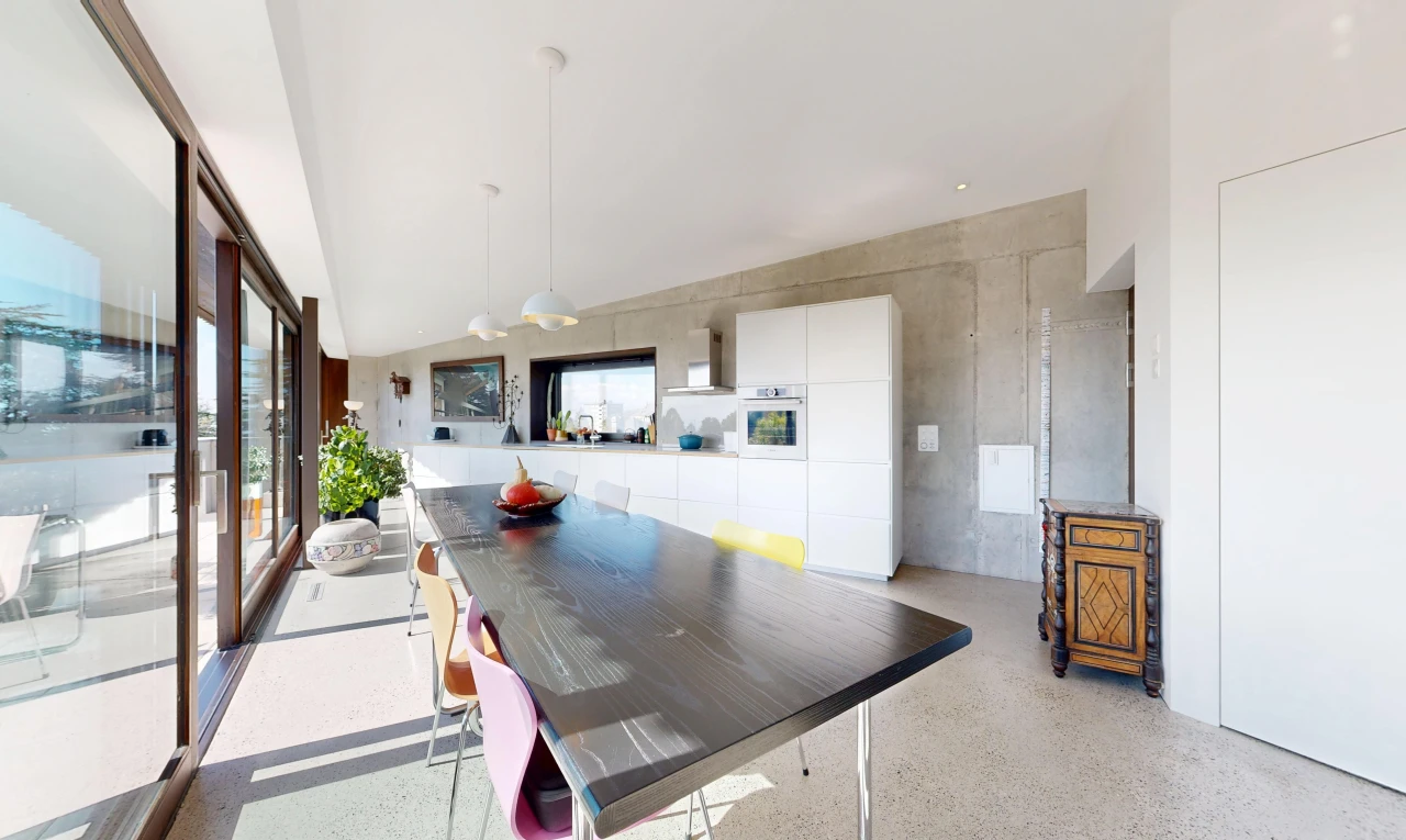 dining room with access to outside, pendant lighting, and dark speckled floor