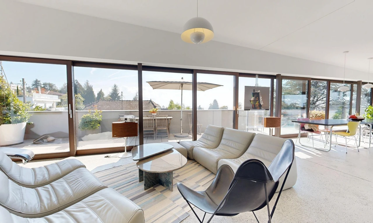 living area featuring pendant lighting, access to exterior, and lofted ceiling