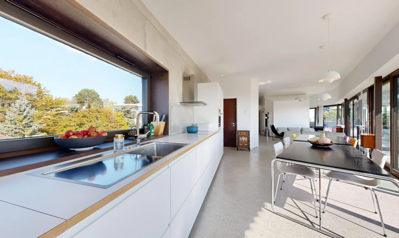 kitchen with decorative light fixtures, light countertops, open floor plan, white cabinets, and black electric stovetop