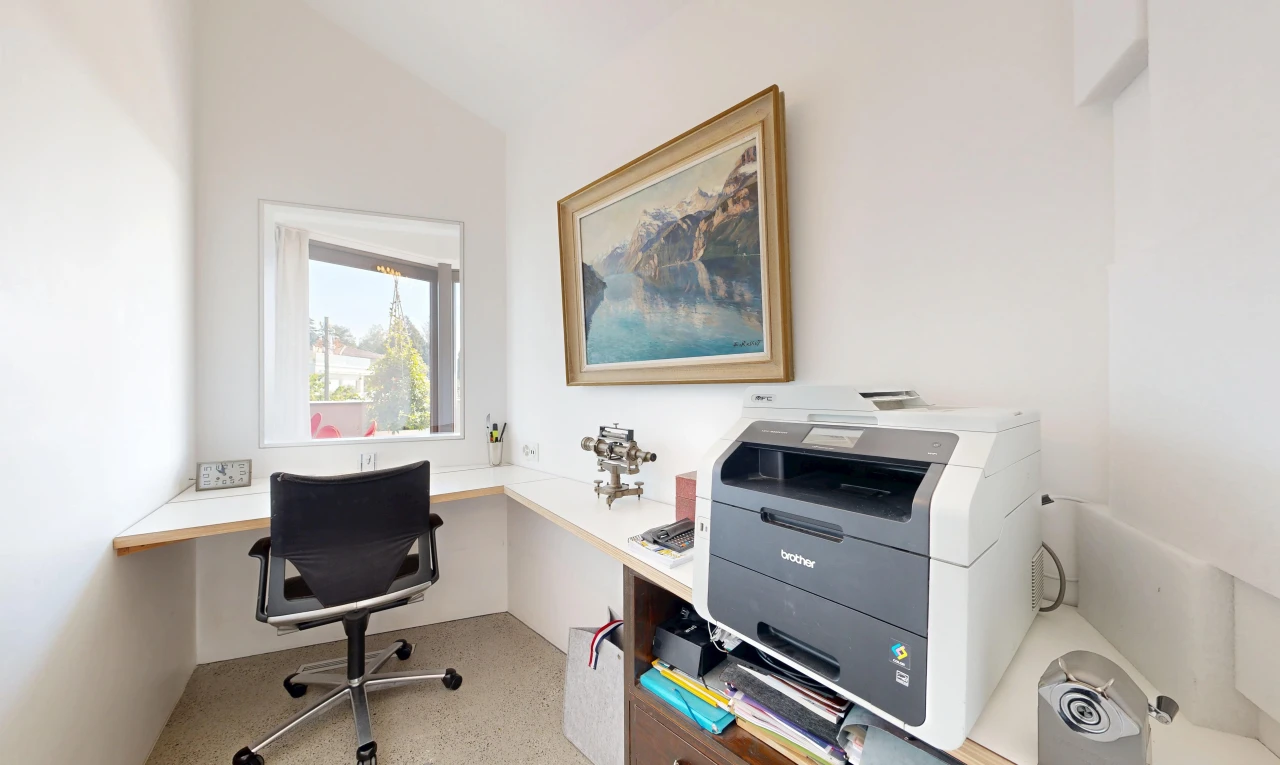 office with built in study area and vaulted ceiling