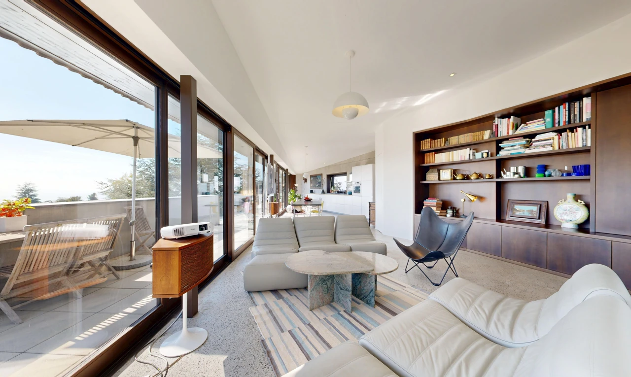 living area featuring built in shelves, access to exterior, pendant lighting, and lofted ceiling