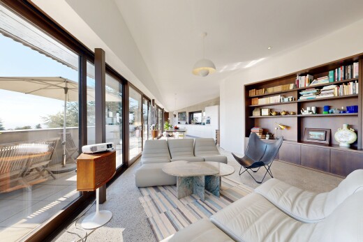 living area featuring built in shelves, access to exterior, pendant lighting, and lofted ceiling