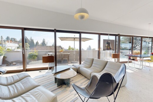 living area featuring pendant lighting, access to exterior, and lofted ceiling