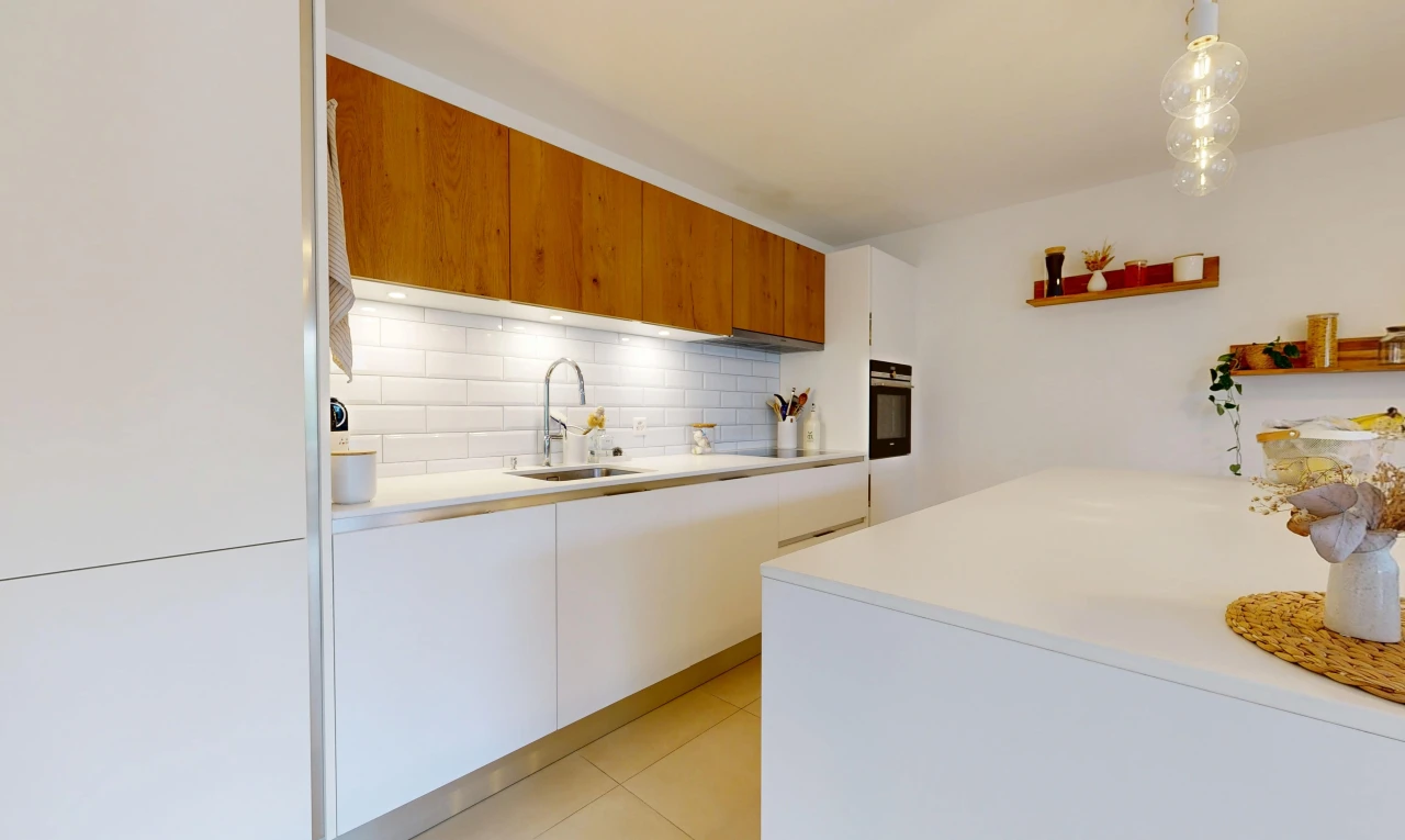dual tone kitchen featuring two tone cabinets, light countertops, modern cabinets, oven, and decorative backsplash