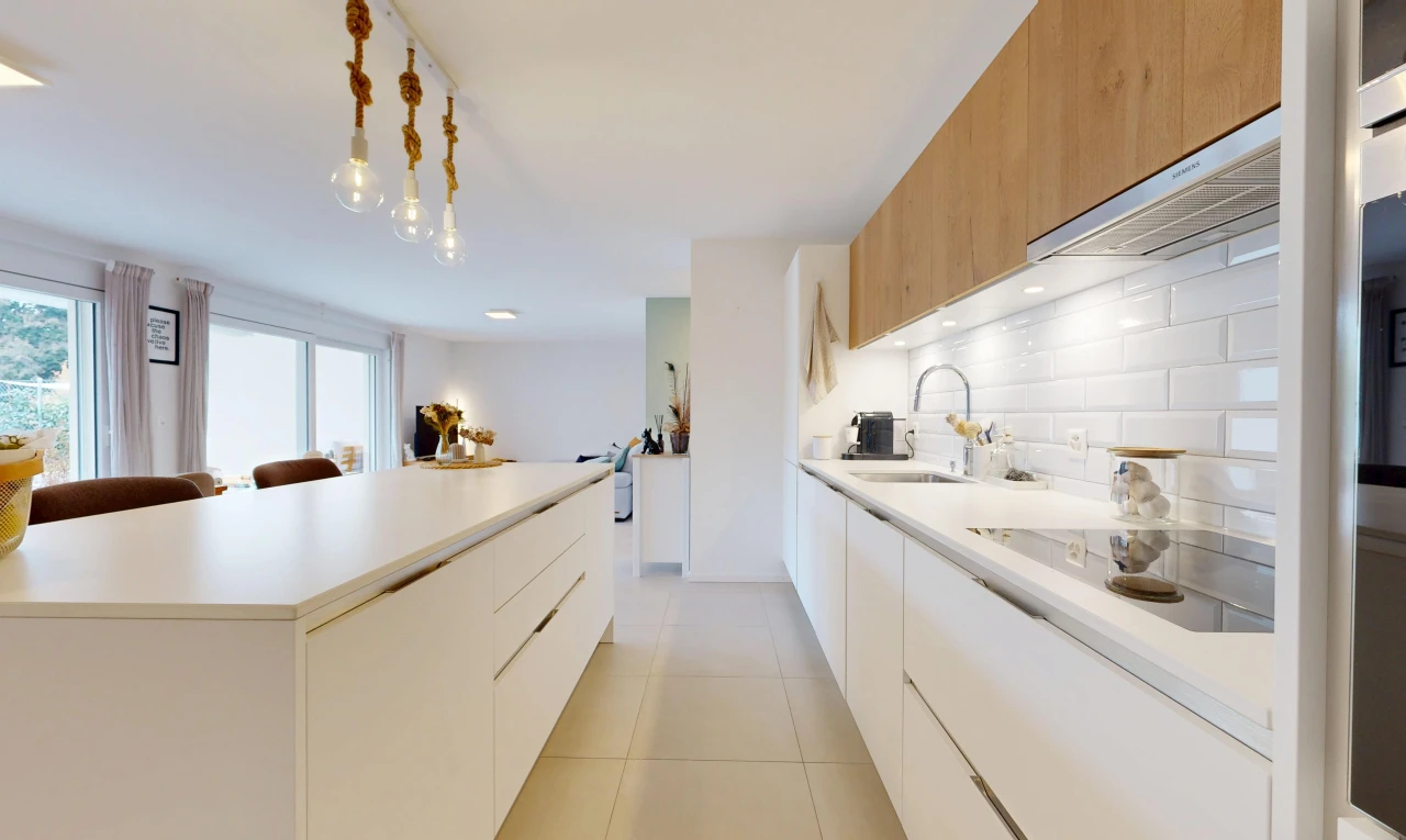 kitchen featuring two tone color scheme, modern cabinets, light countertops, and a kitchen island
